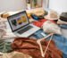 clothes-laptop-bed-arrangement-high-angle